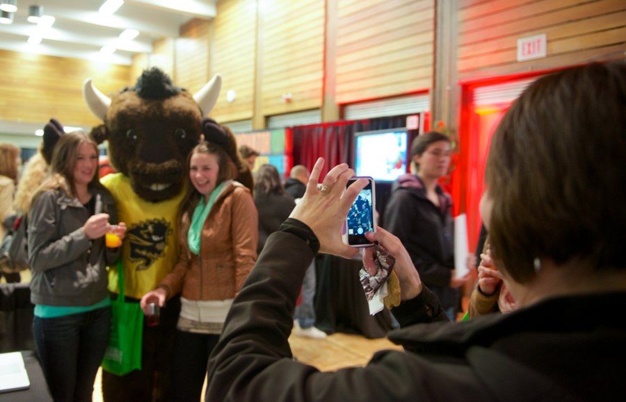 students pose with Bison mascot