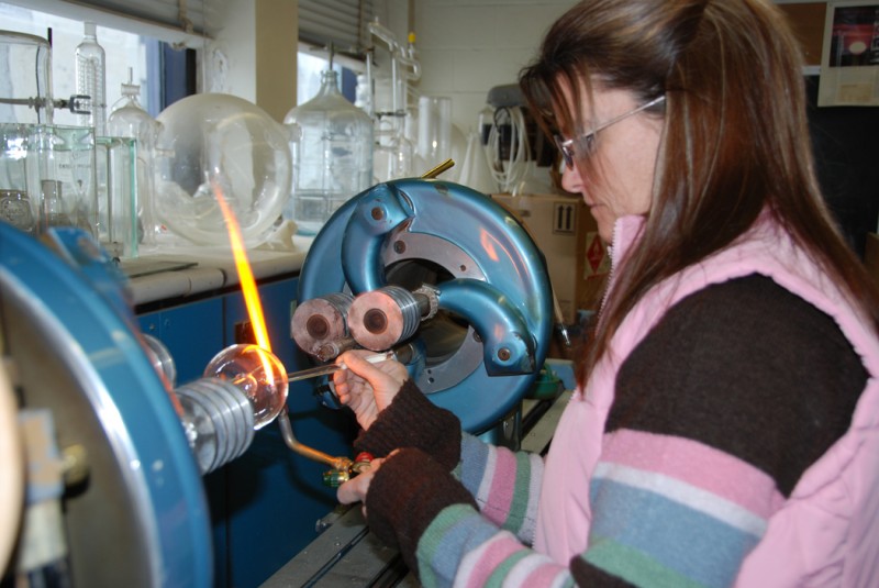Lesa Cafferty at work in the glass-blowing lab.