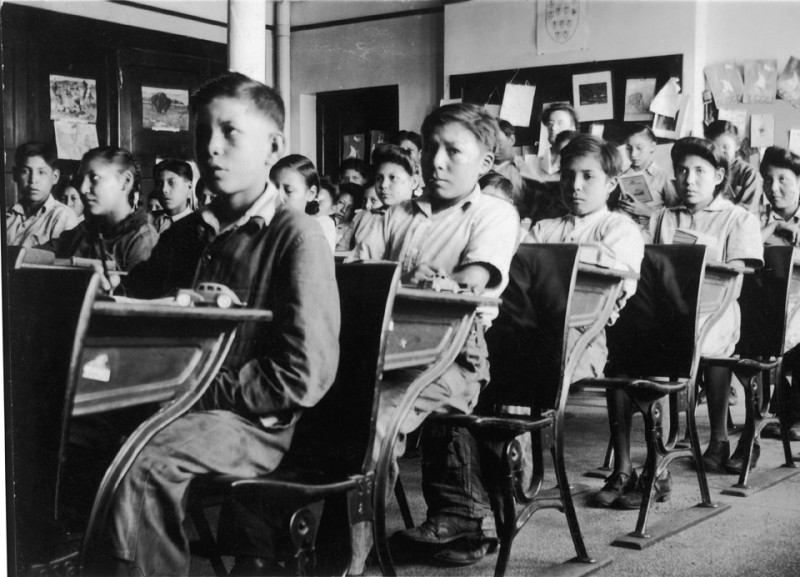 students at desks in a residential school