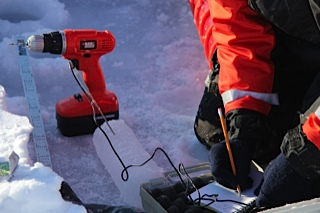 Scientists taking temperature readings from an ice core.