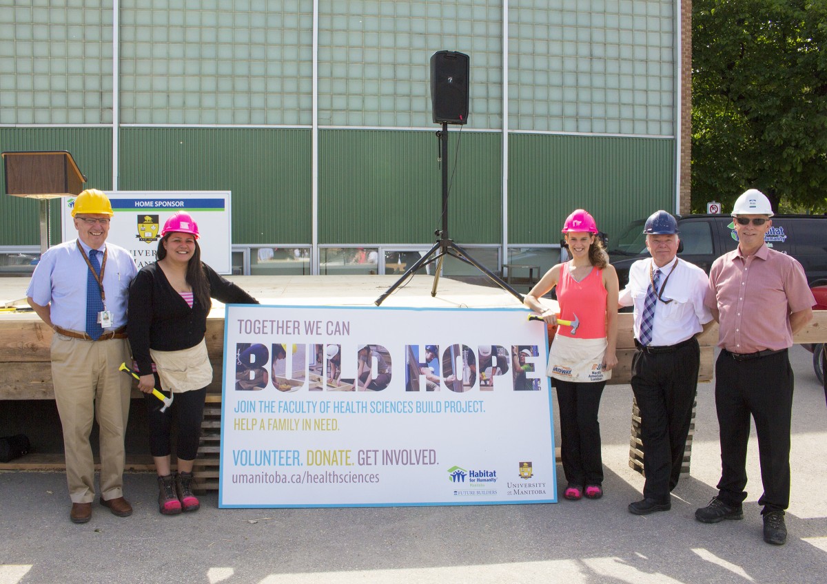 At the Habitat build launch (l to r), Dean Brian Postl, new homeowner Michelle, Med 2 student Gail Pollard, Dr. Bruce Martin and Habitat for Humanity Manitoba CEO Sandy Hopkins.