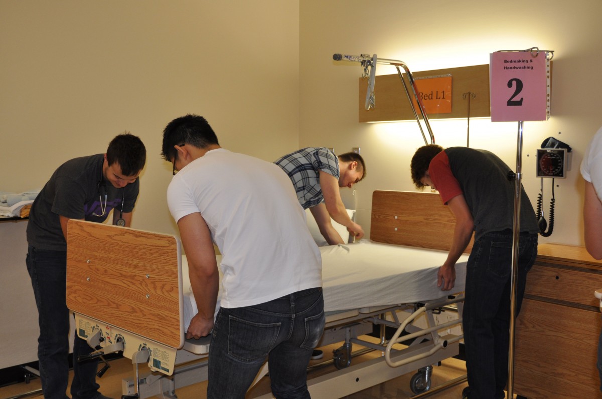 College of Nursing students change bed sheets at Skills Blitz