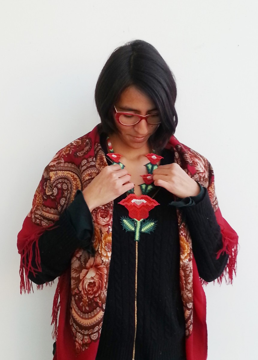 Alaide Vences Estudillo keeps an altar on her desk on which she keeps necklaces and other treasures from her home, such as this beaded necklace.