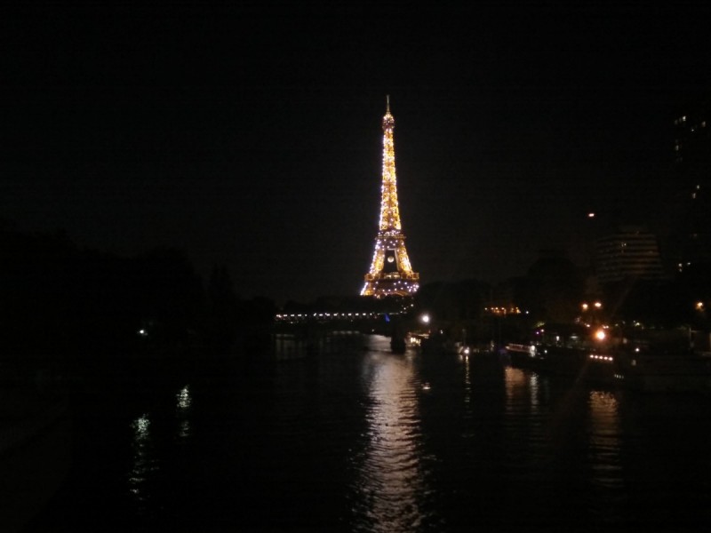 A view of the Eiffel tower at night. 