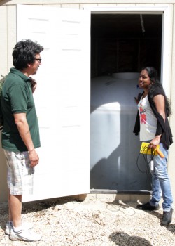 PhD student Geethani Eragoda (right) checks out a water storage tank.