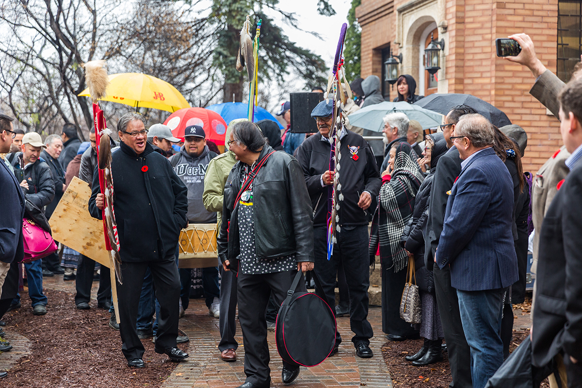 As the ceremonial march from the National Centre for Truth and Reconciliation starts, Carl Stone (centre) brings smiles to those around him with one of his many stories.