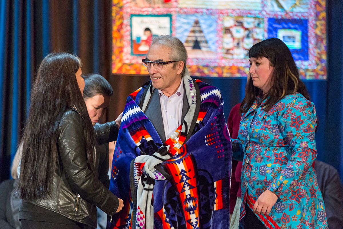 A smudging ceremony followed as an eagle feather fanned Fontaine's troubles off him and back to the Creator. Fontaine was then given new moccasins and wrapped in a blanket, so he can walk lighter and better.