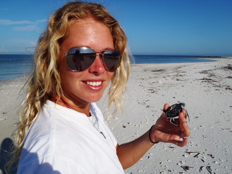 Rankine holds a sea turtle hatchling from a project she was working on in Florida in 2011