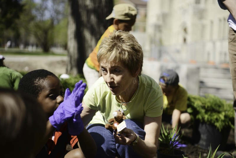 Making the place she loves even more beautiful, Dr. Keselman gardens with children on Campus Beautification Day 2013