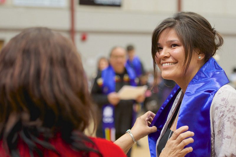 Indigenous students receive specially-designed scarves at the annual Graduation Pow Wow, to celebrate their achievements together. Embedded with elements of cultural significance, the scarves were approved as official academic dress for convocation in 2016.