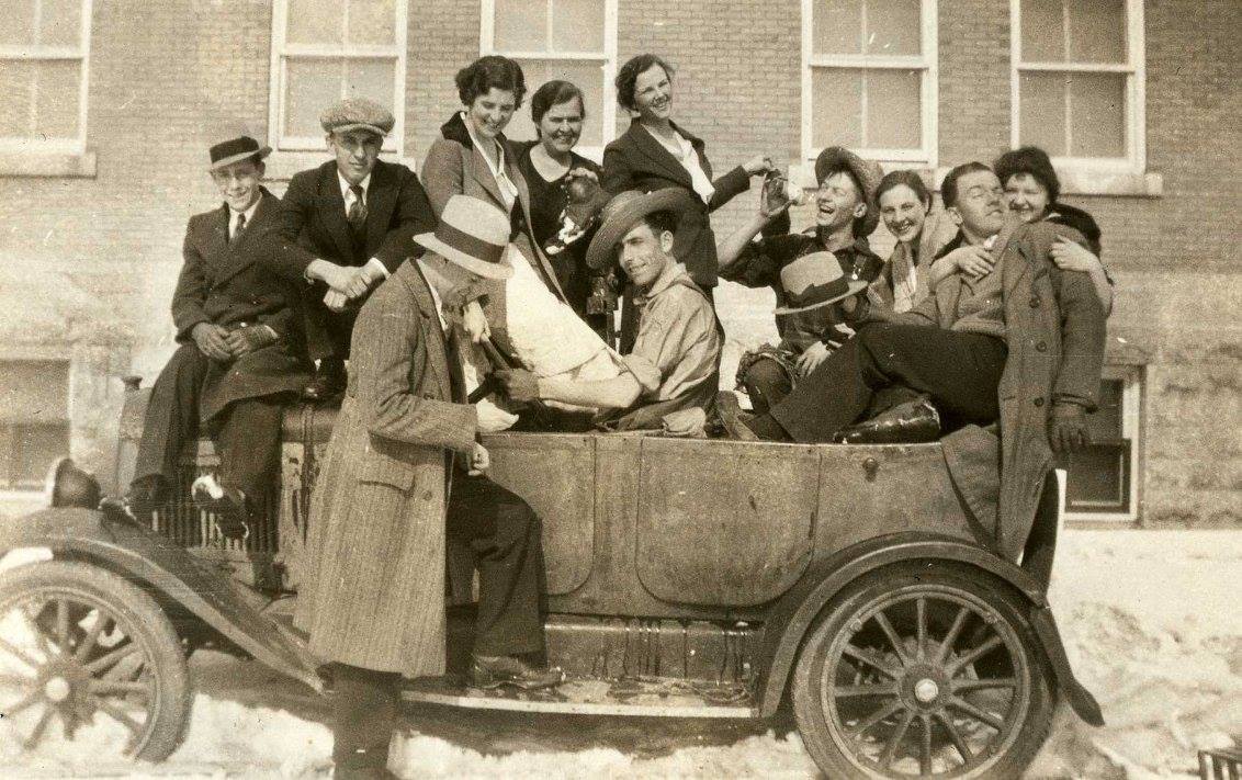 A photograph of a group of eleven agriculture and human ecology students, the cast of a one-act play, sitting in and on a car. The photograph is dated 1933.<br />
Source: Faculty of Human Ecology fonds