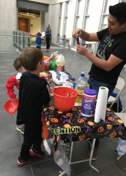 Demonstrating experiment to kids at the Spooky Science event