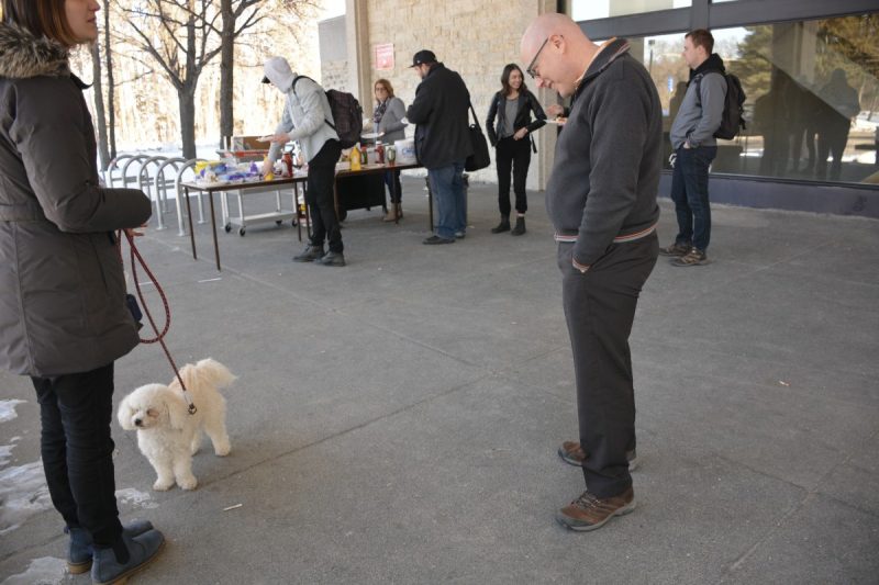 Finnegan makes Professor Bruce Curran smile at Robson Hall's annual Wellness Days.