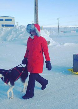 Amy with Arrow the husky pulling home a sled full of food mail. // Image from AMY BROWN @rock.water.sky (Instagram)