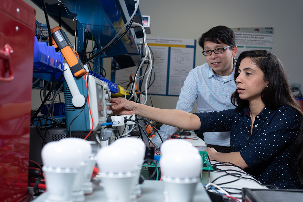 Carl Ho with PhD student Radwa Abdalaal, conducting an experiment to evaluate their patented Power Quality Conditioning Technology.