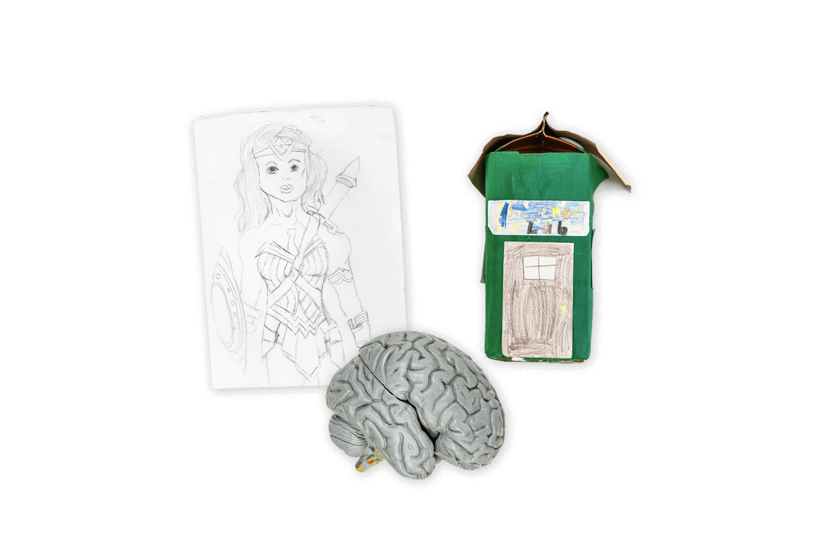 A child's drawing of Wonder Woman, a black and white image of a brain, and a child's art piece made from a milk carton.
