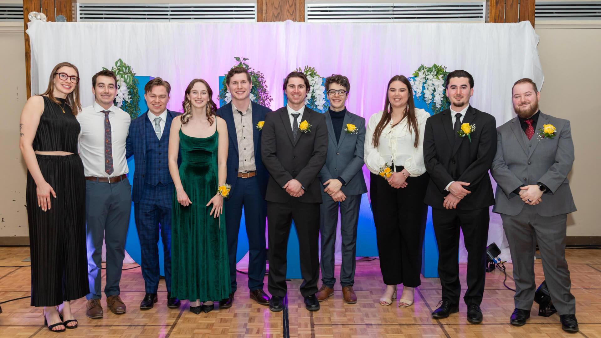 students in formal dress posing at celebration event