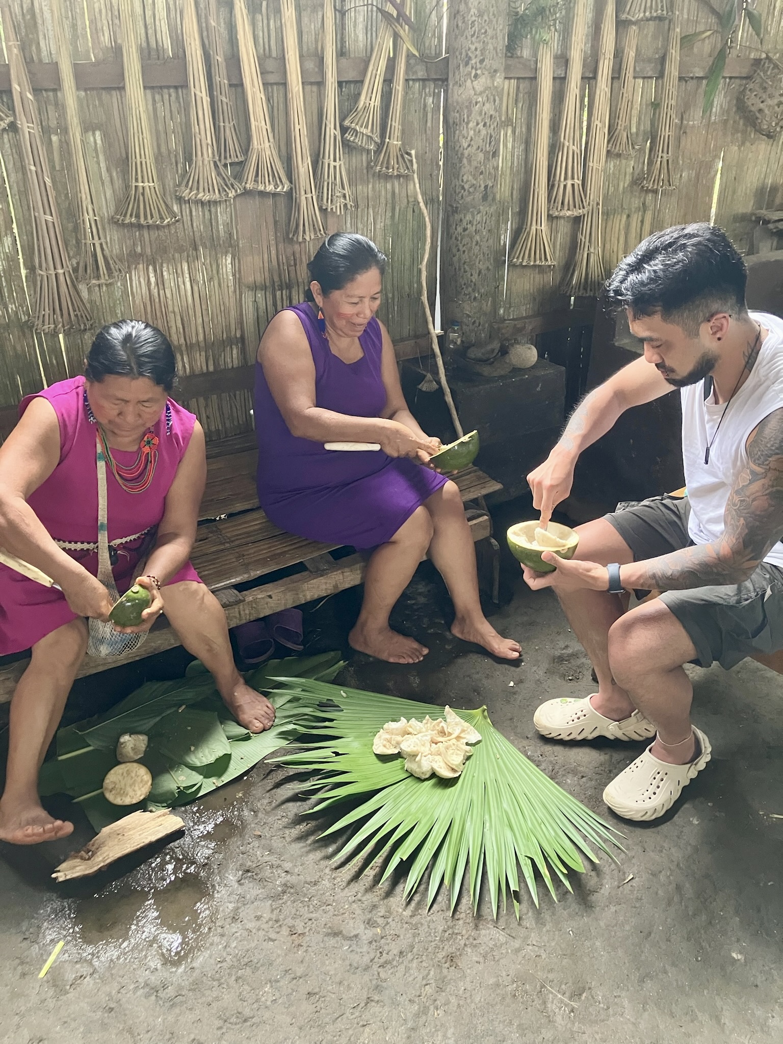 Three people prepare fruits.