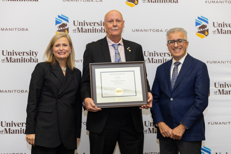 Chancellor Anne Mahon and President Michael Benarroch present award to Grant Pierce.