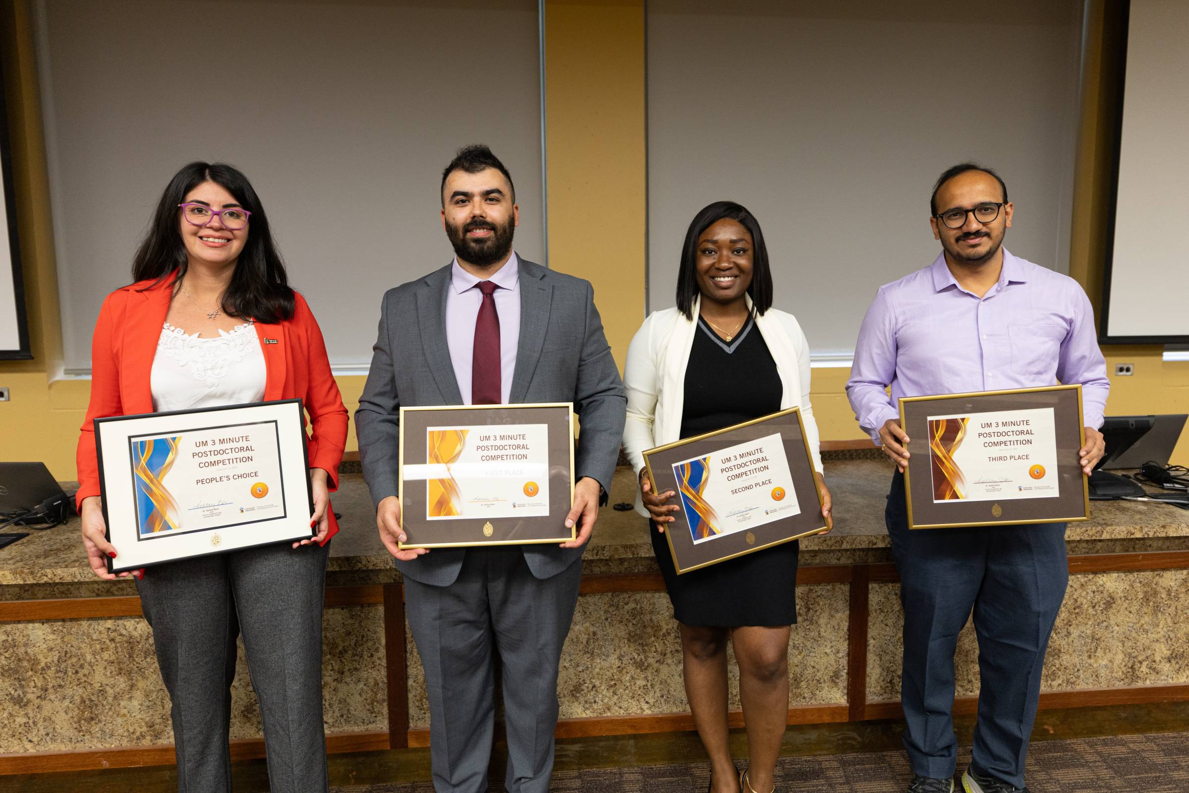 Mariela Rodriguez, Michael Saley, Olabisi Akinlabi, and Asim Joshi holding certificates.