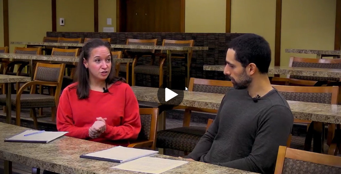 Video screenshot with two people talking