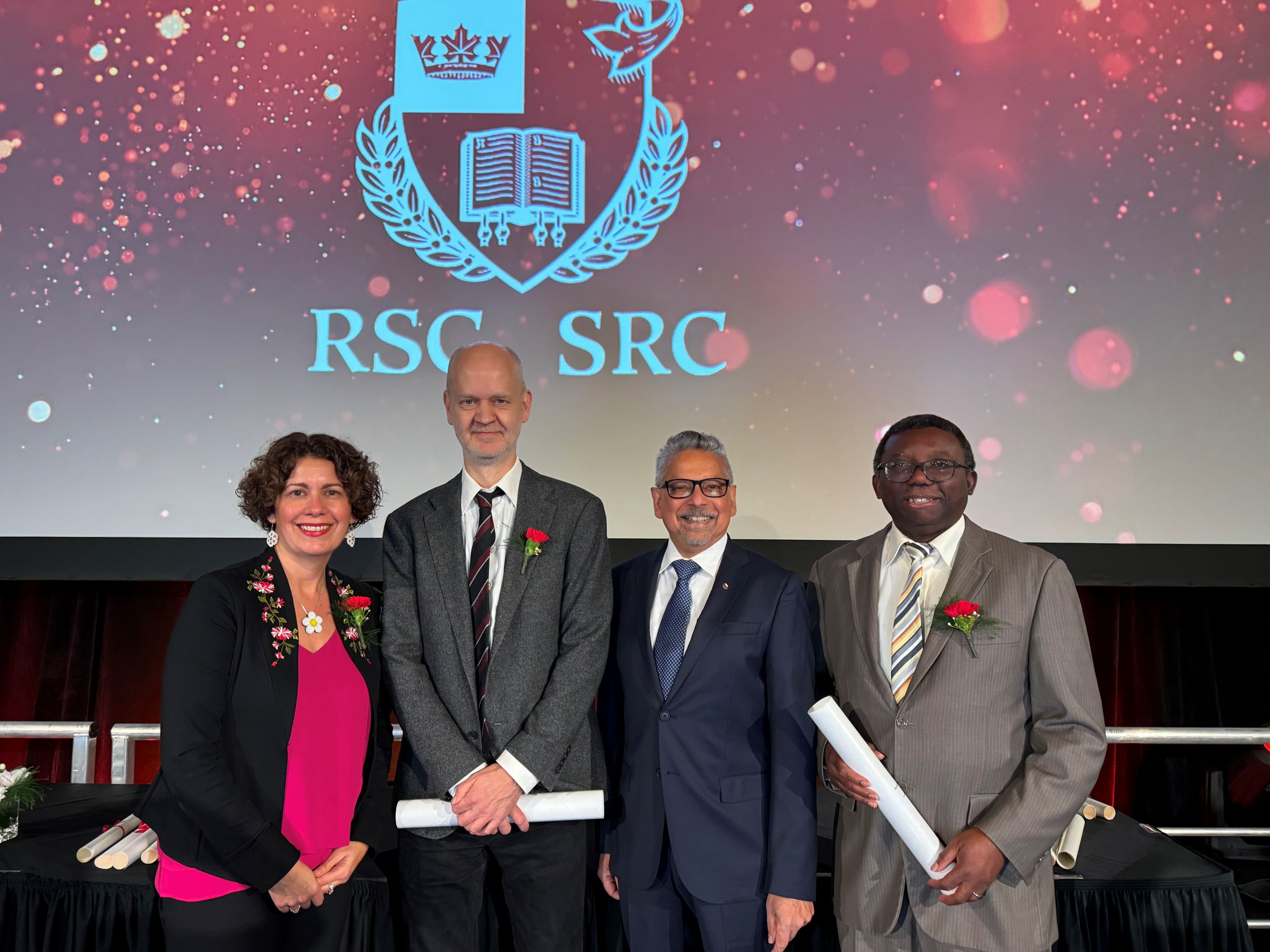 Dr. Mario Pinto, Vice President (Research and International) pictured with three RSC scholars on stage at the ceremony in Waterloo, Ontario.