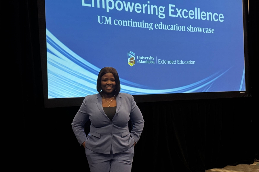 Woman stands before a screen that says Empowering Excellence