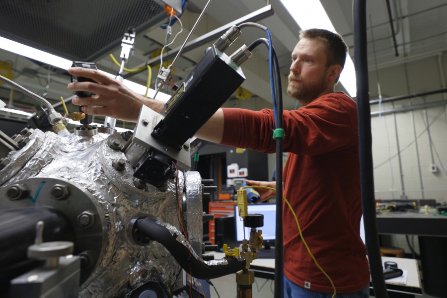 Student tinkers with spherical engine in a laboratory