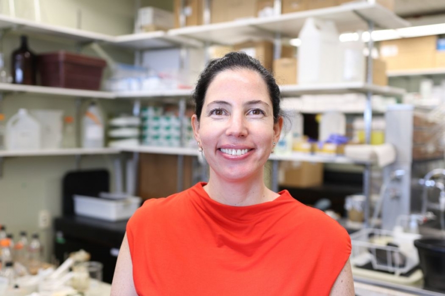 Dr. Zulma Rueda smiling at the camera in her lab.