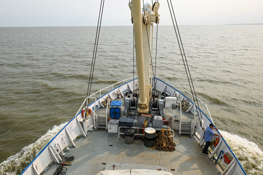 Photo of a research vessel on the lake with one crew memeber