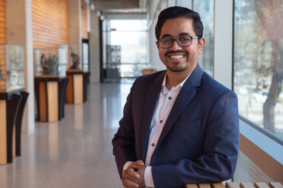 Md. Abdul Aziz smiling at the camera in a hallway at the Apotex Centre.