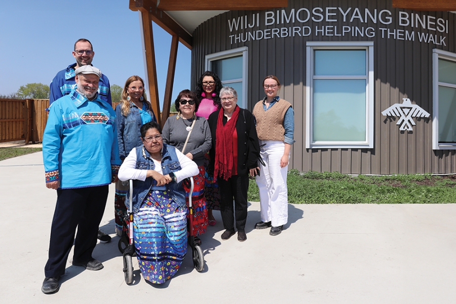 Eight people pose for a group photo outside Wiiji Bimoseyang Binesi.