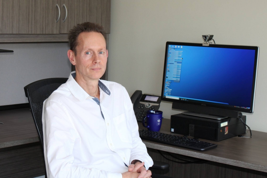 Dr. Stephen Kirkland sitting at a desk in front of a computer.