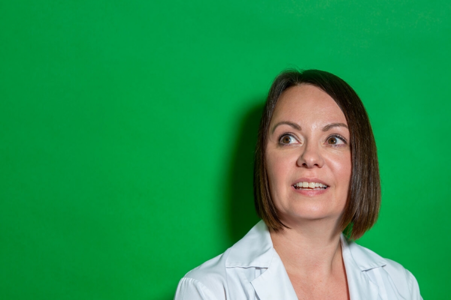 A woman against a green backdrop