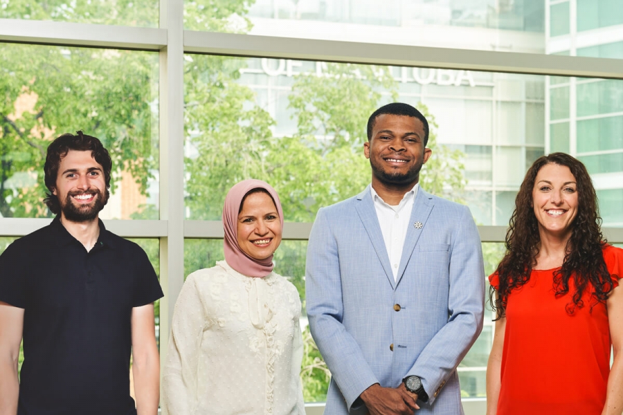 Four students smile for the camera