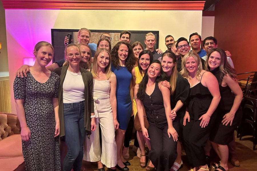 a group of university alumni gather and pose for a photo