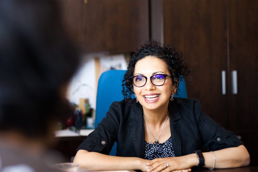 Samar Safi-Harb wearing a black coat and an eyeglass.