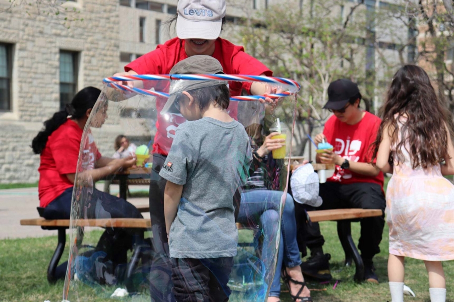 A kid inside a giant bubble at Science Rendezvous 2023.