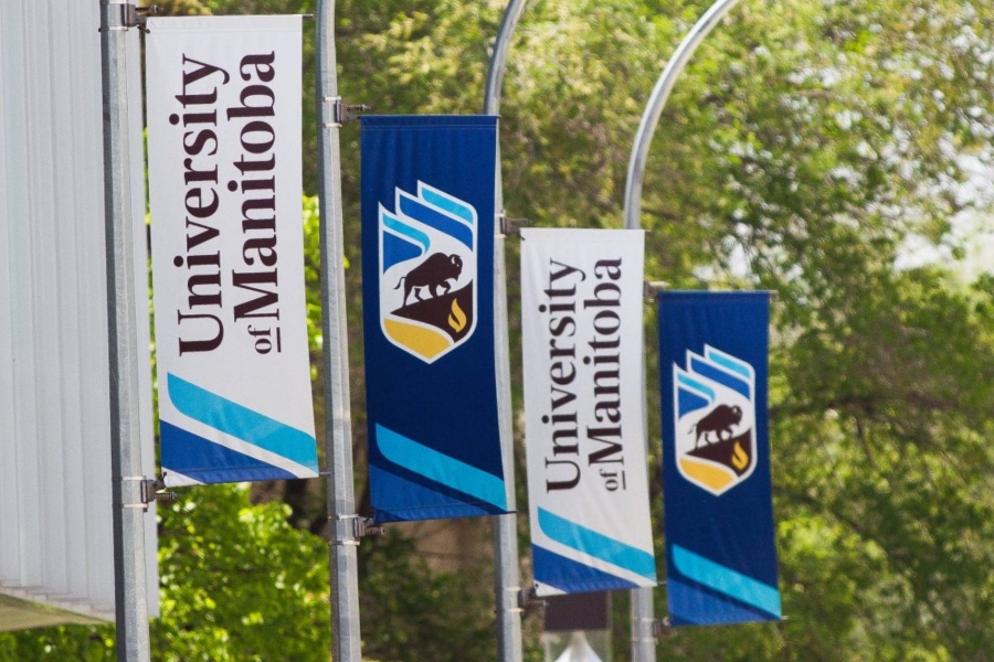 Four branded University of Manitoba banners hanging from light posts.