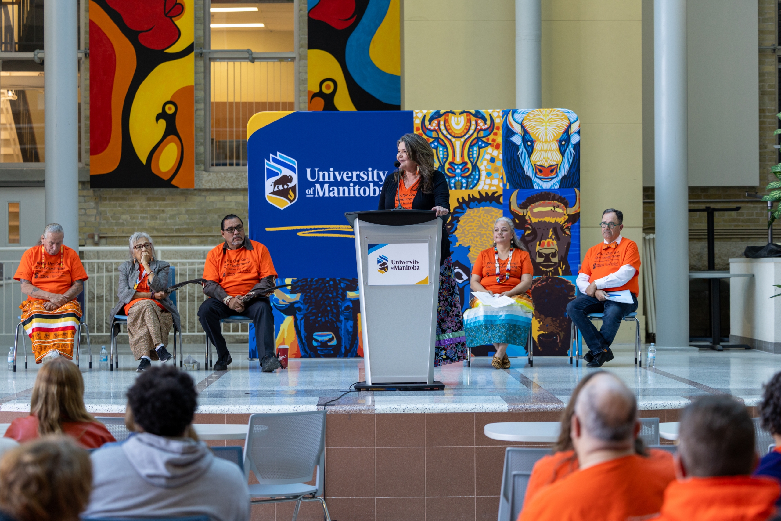 Melanie MacKinnon, executive director of Ongomiizwin – Indigenous Institute of Health and Healing, speaks onstage.