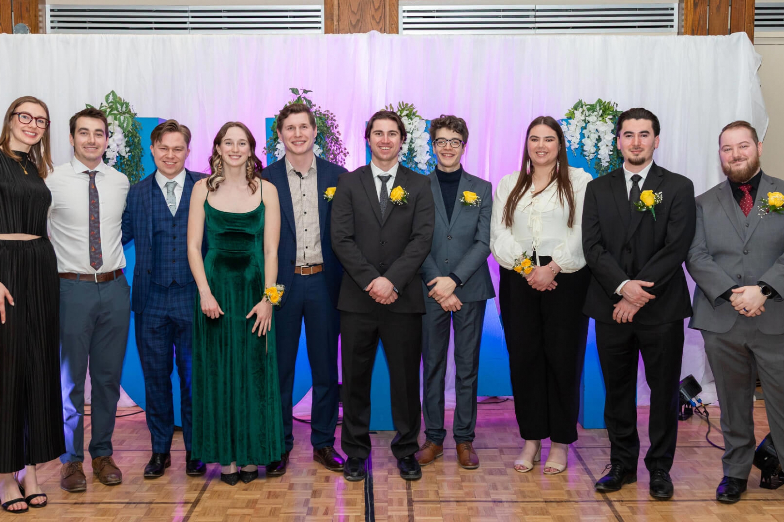 group of smiling students in formal wear
