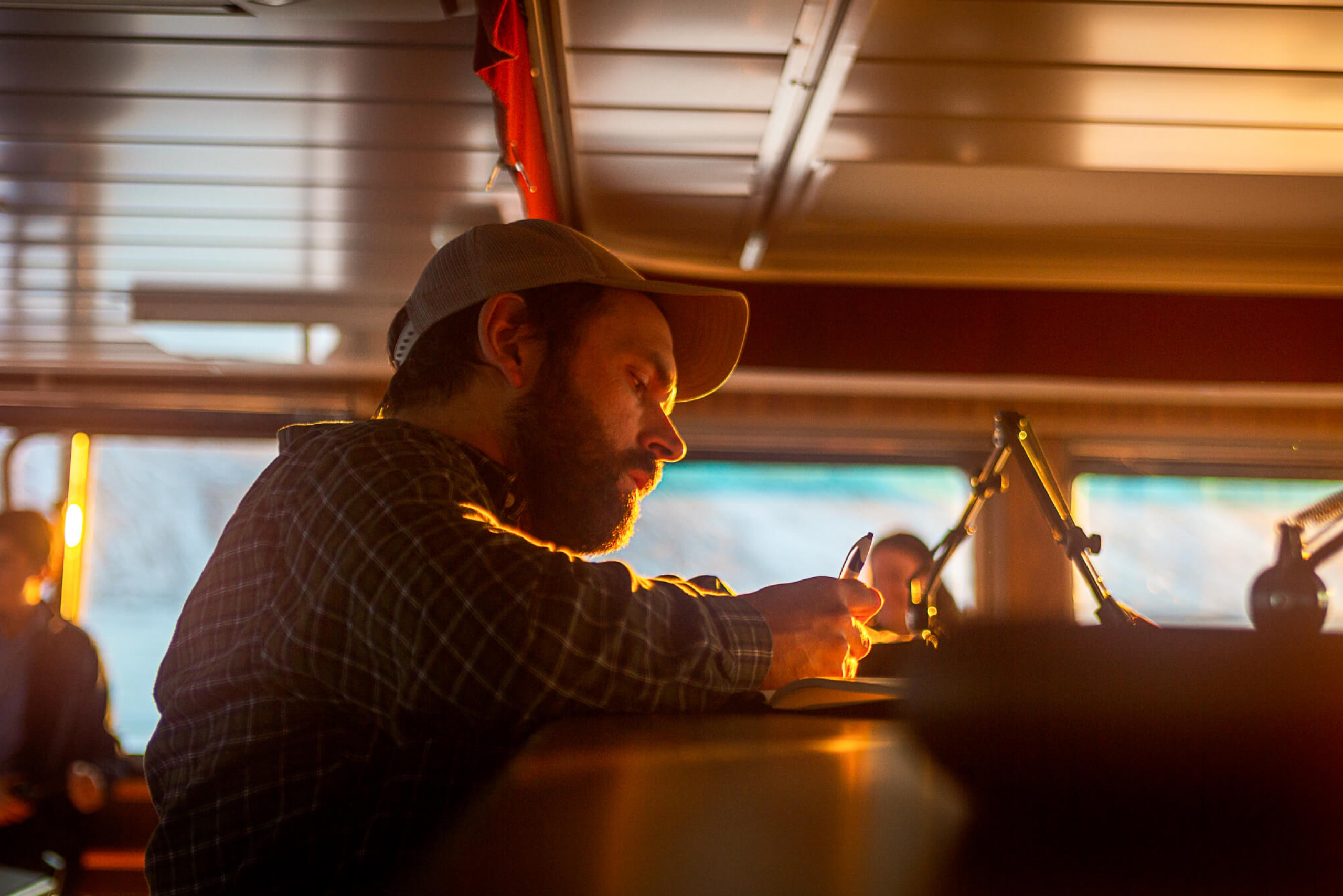 A man is writing on paper