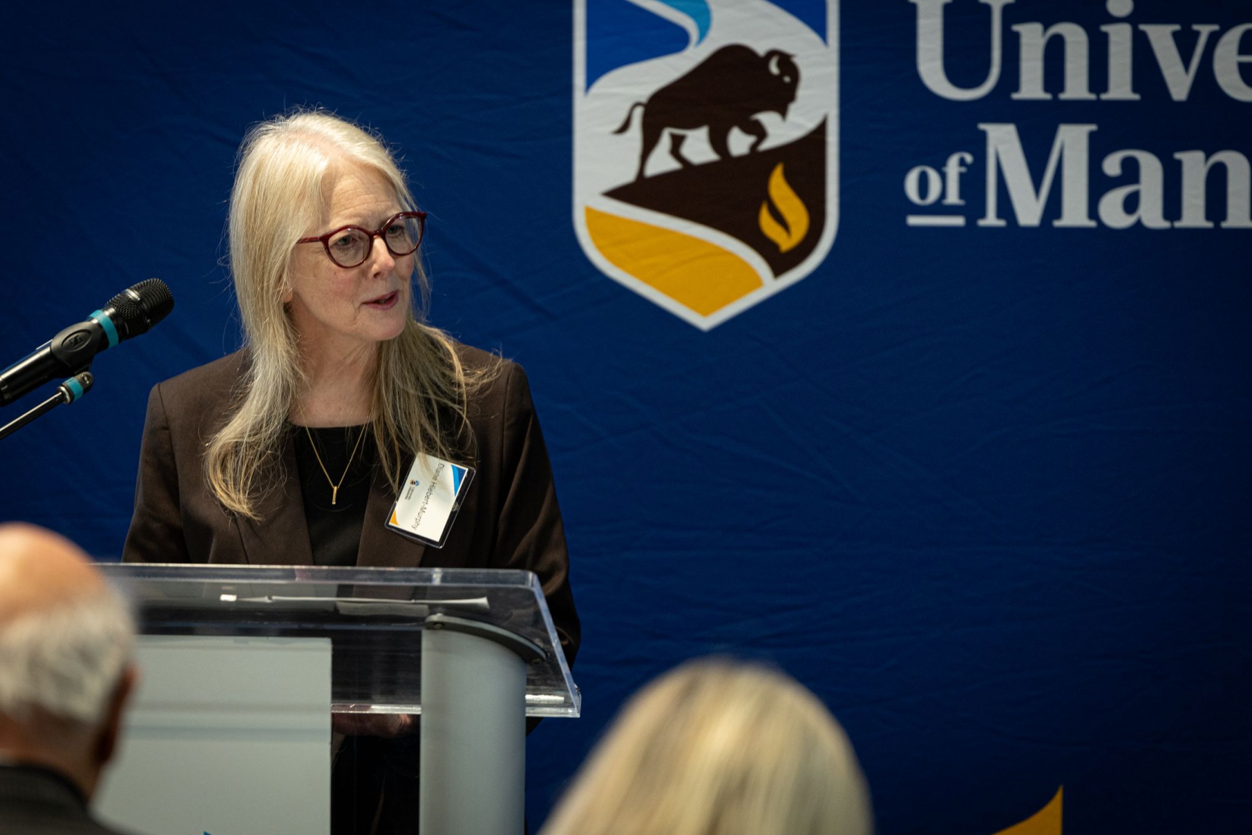 Diane Hiebert-Murphy speaking at podium.
