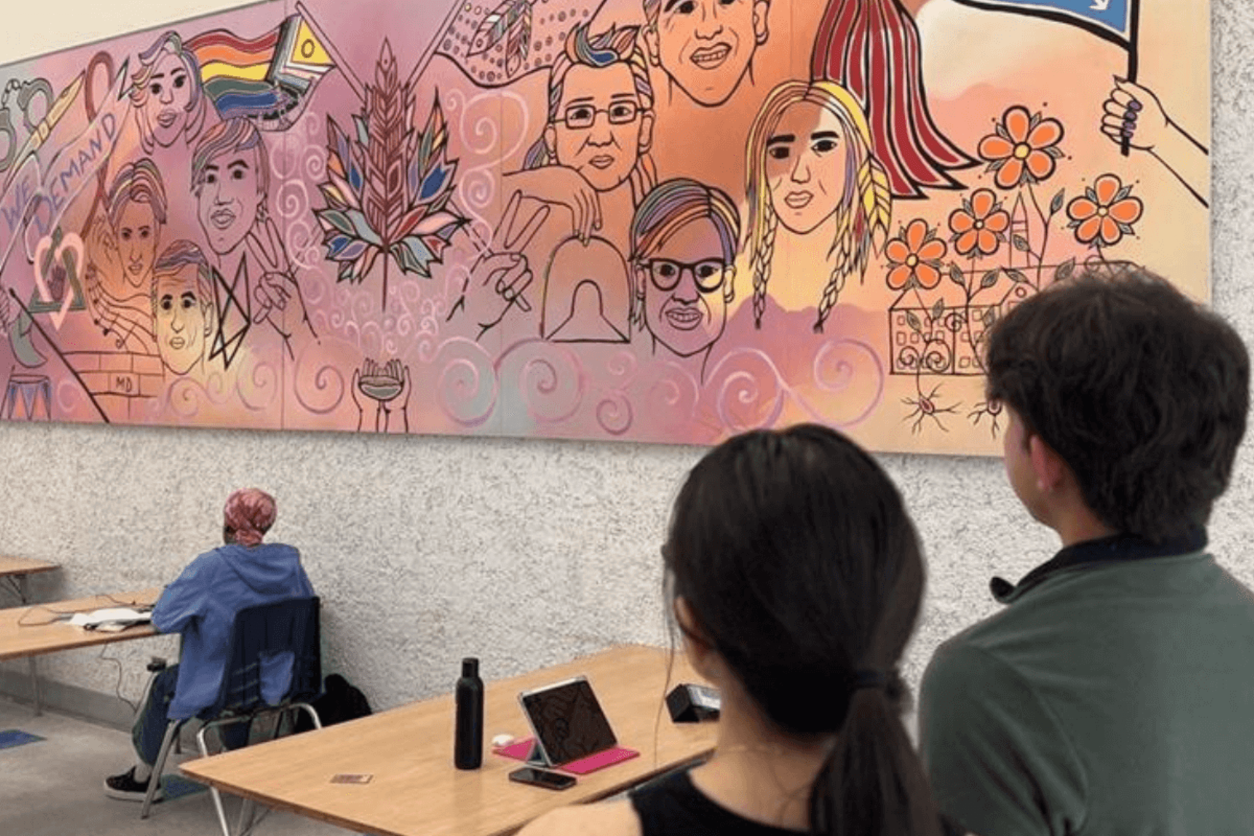 students looking at art mural.