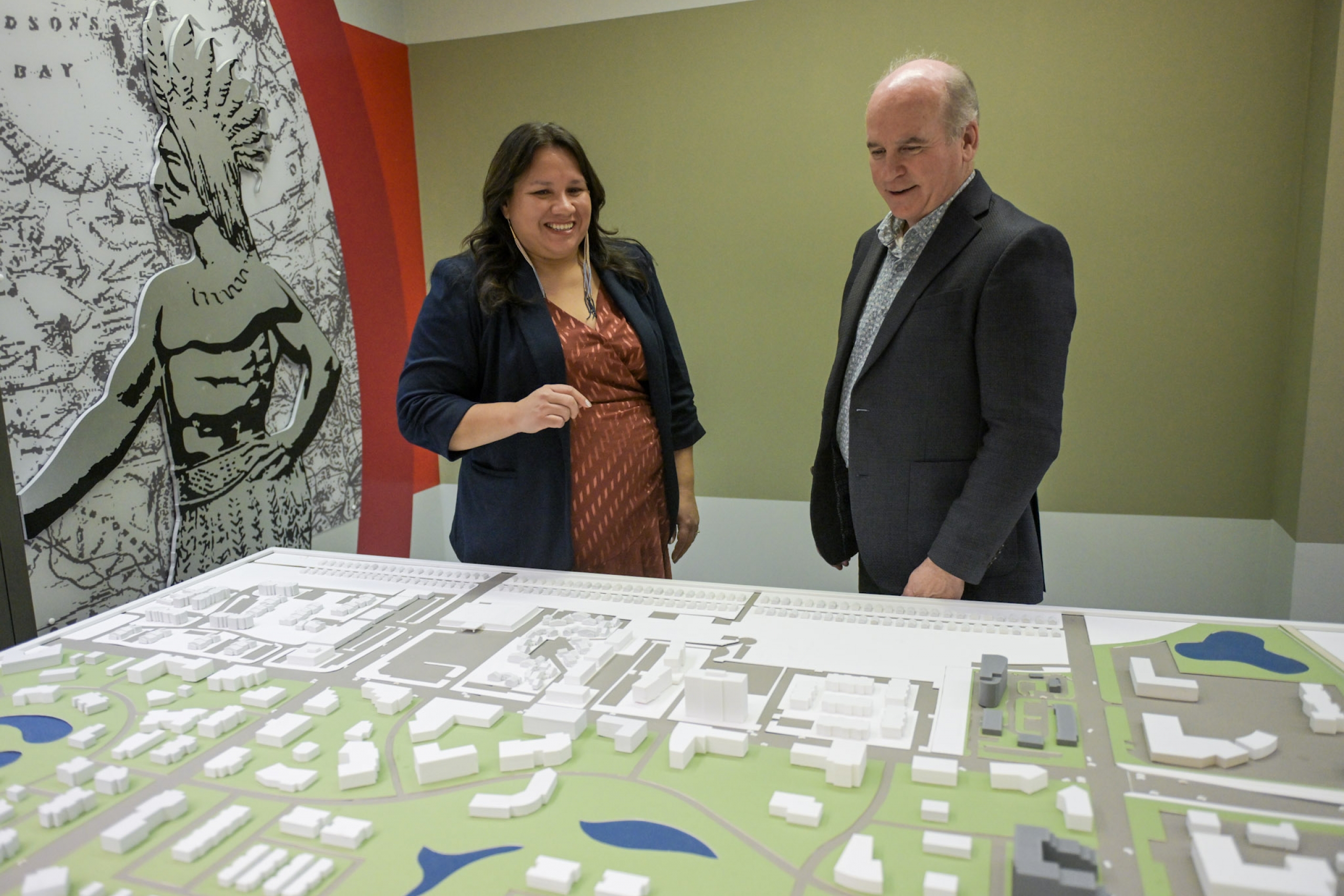 Woman and man standing in front of a diorama. 