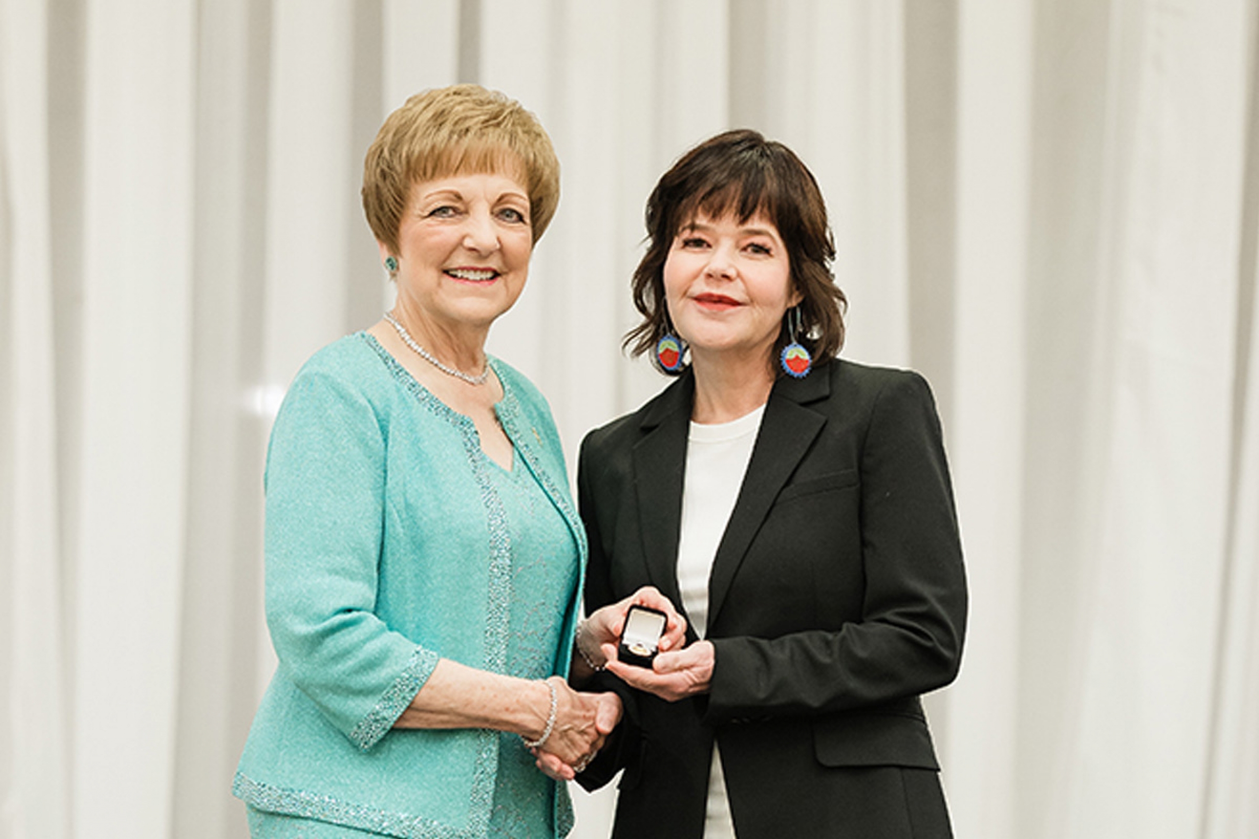 Angela Sousby onstage with Dr. Netha Dyck, recieving her nursing pin.
