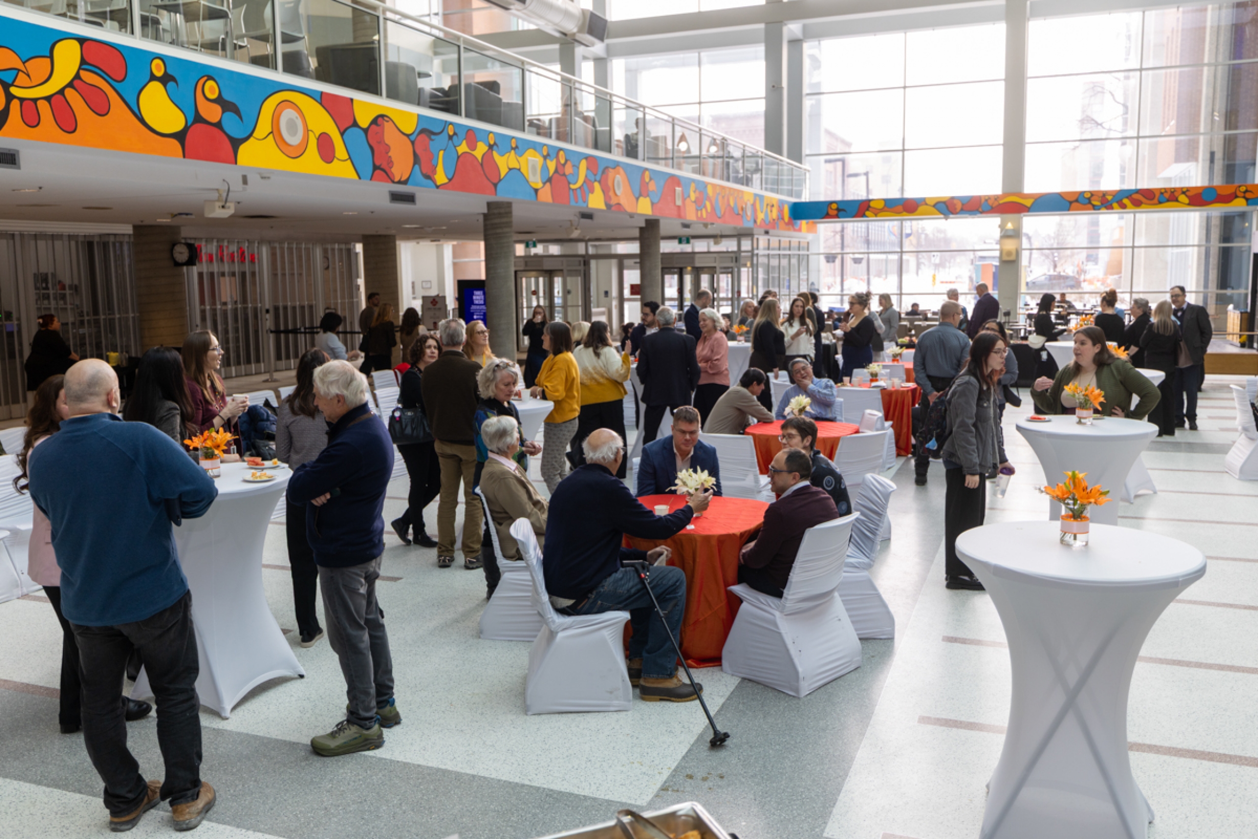 A crowd at the Brodie Atrium, in a wide open space.