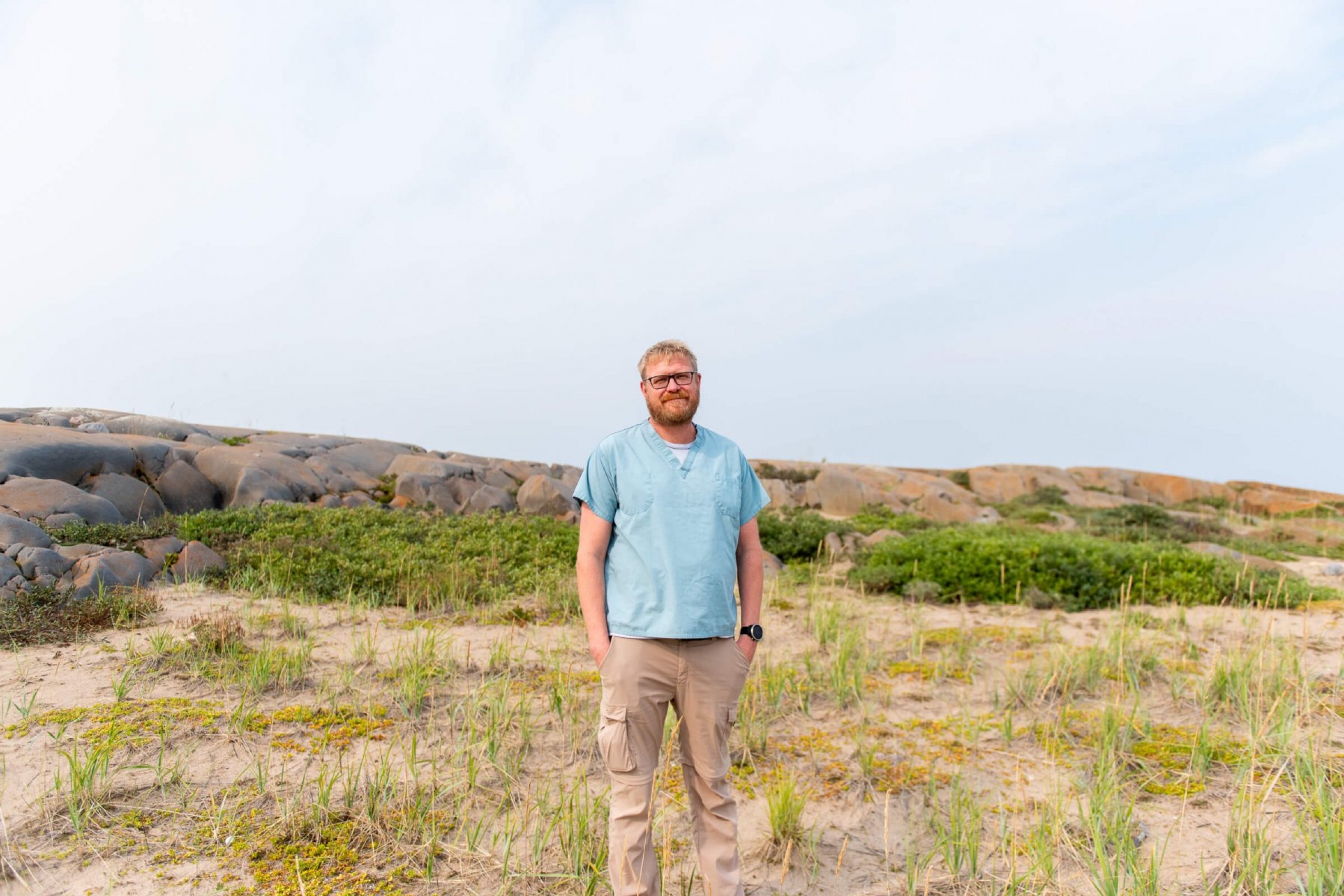 A doctor stands outside