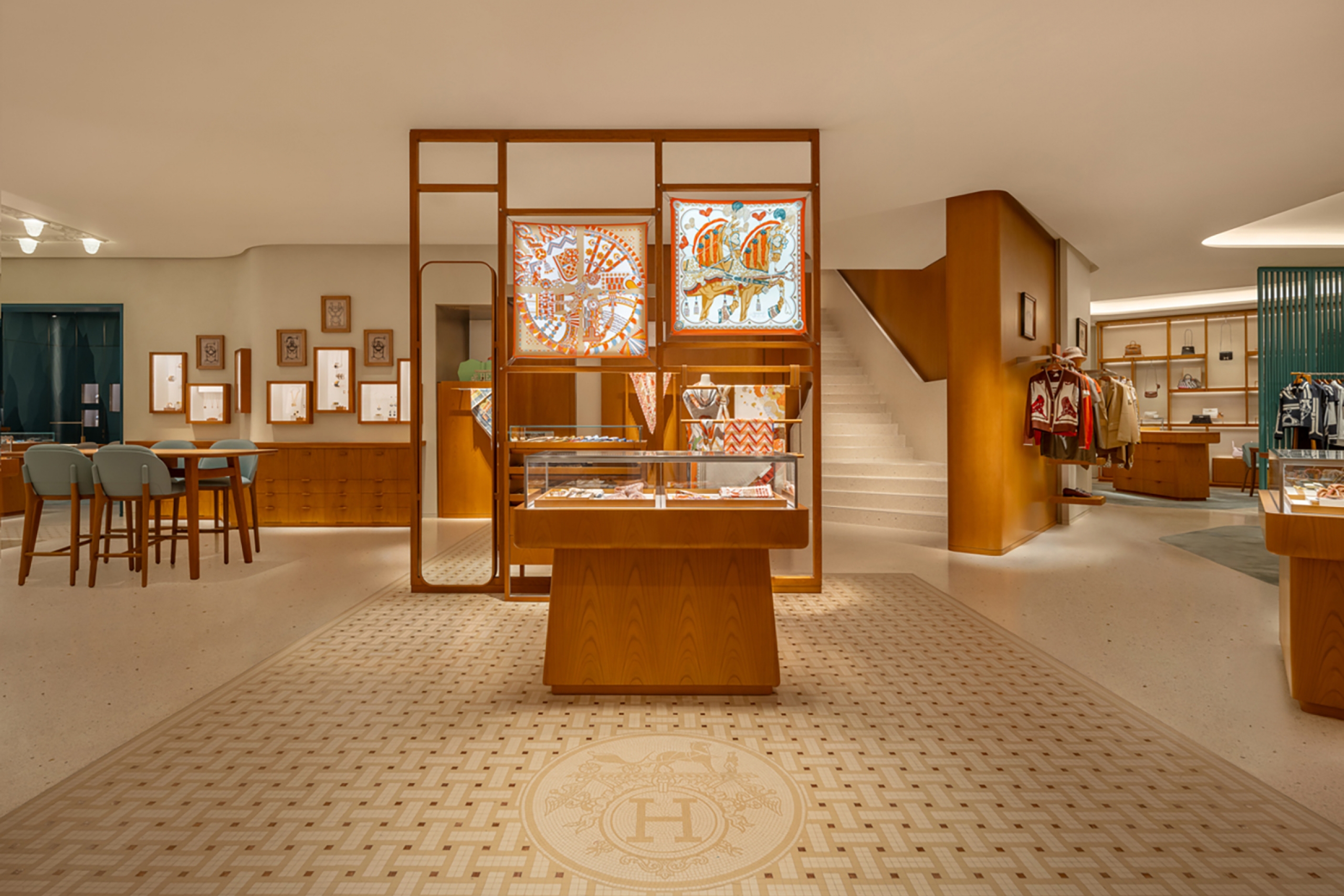 Luxurious boutique interior with wooden displays, patterned rugs, and elegant lighting. Stairs lead up, while clothes and accessories are visible. Warm, inviting atmosphere.