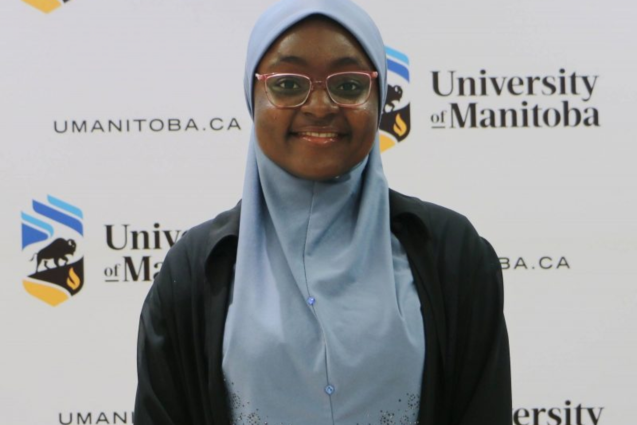 Young smiling woman wearing a blue hijab